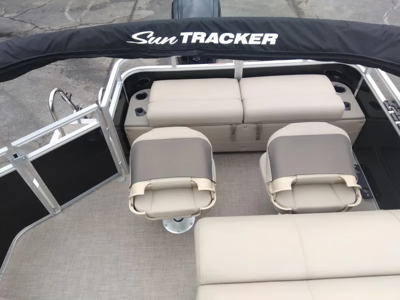 Slide: The Image of 2025 Sun Tracker SportFish 22 DLX boat interior with seating and canopy. - 7