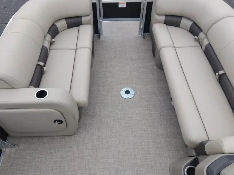 Slide: The Image of 2025 Sun Tracker SportFish 22 DLX interior with beige seating and cup holders. - 9