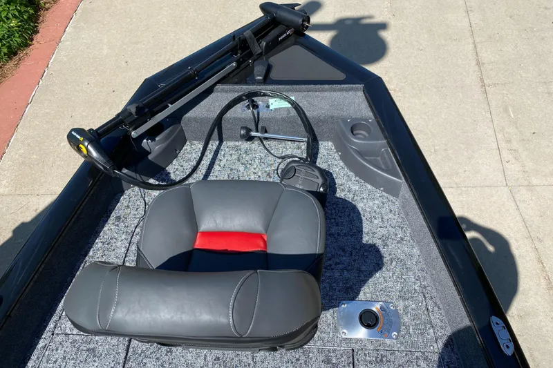 Slide: The Image of 2025 Tracker Pro Team 175 Crappie Edition boat interior with gray and red seating. - 3