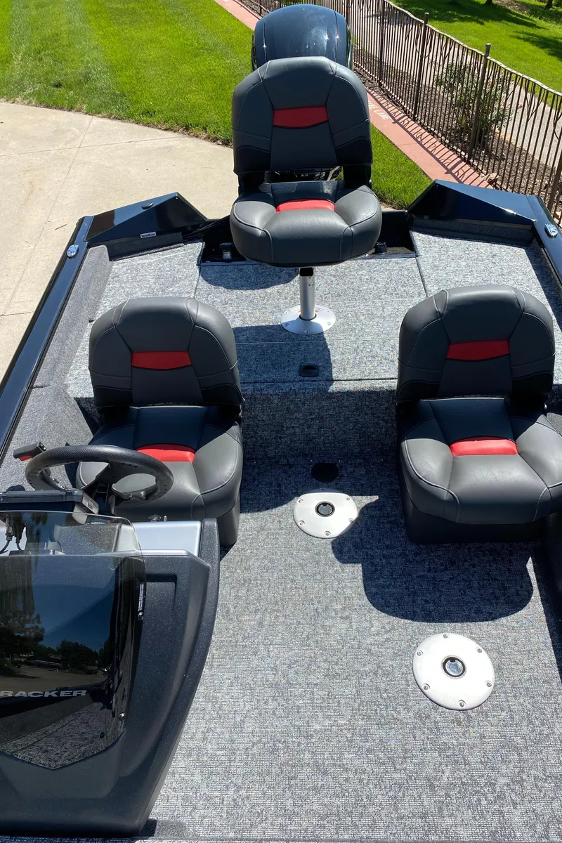 Slide: The Image of 2025 Tracker Pro Team 175 Crappie Edition boat interior with three seats and steering console. - 4