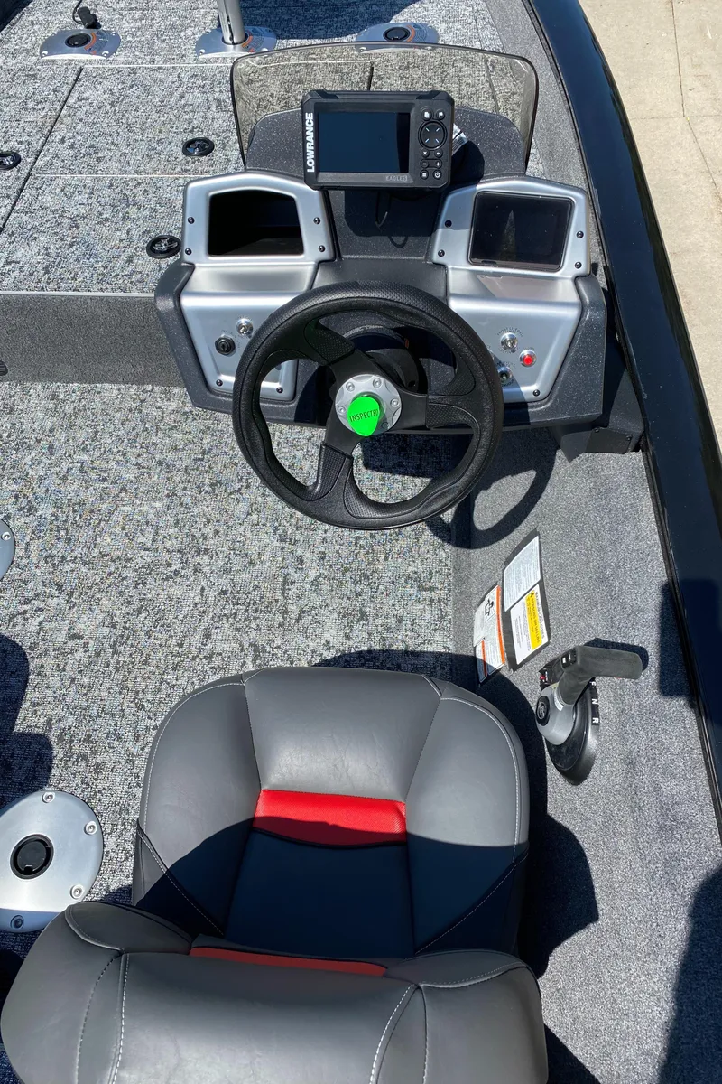 Slide: The Image of 2025 Tracker Pro Team 175 Crappie Edition boat interior with steering wheel and control panel. - 5