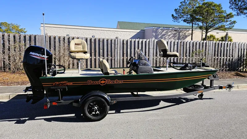 Slide: The Image of 2025 Tracker Bass Tracker Classic Limited boat on trailer, parked outdoors. - 2