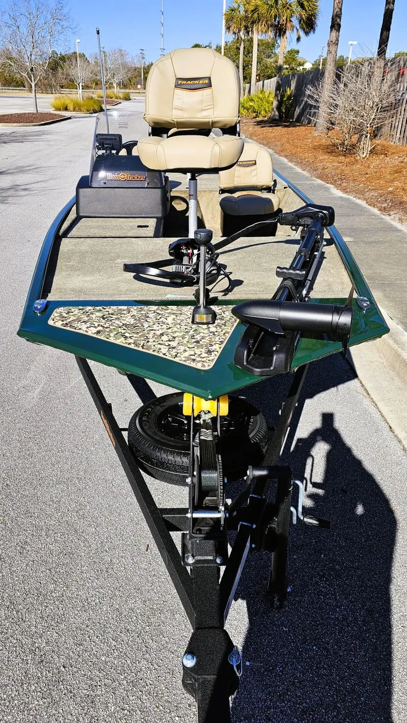 Slide: The Image of 2025 Tracker Bass Tracker Classic Limited boat on trailer, featuring seating and fishing equipment. - 7