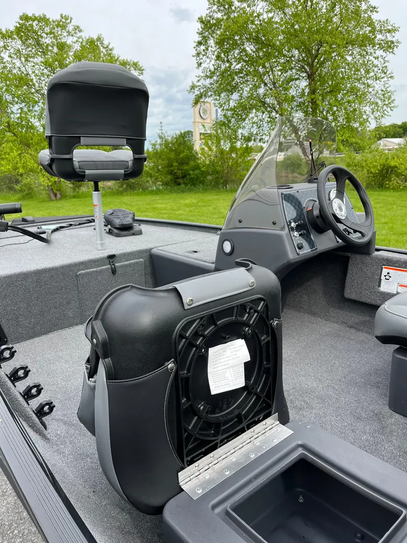 Slide: The Image of 2025 Tracker Bass Tracker Classic XL interior with seating and steering console. - 4