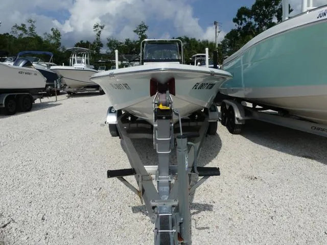 Slide: The Image of 2017 Sea Pro 172 boat on trailer, parked among other boats, under a partly cloudy sky. - 2