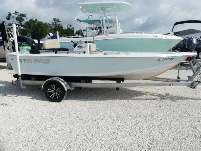 Slide: The Image of 2017 Sea Pro 172 boat on trailer, parked on gravel, with other boats in the background. - 4