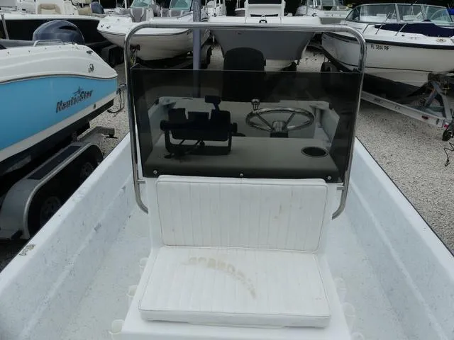Slide: The Image of 2008 KenCraft Boats 1860 SKIFF, center console view, parked among other boats. - 13