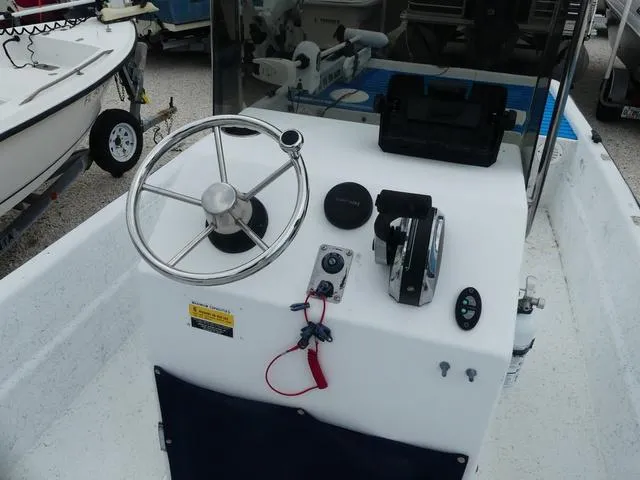 Slide: The Image of 2008 KenCraft 1860 SKIFF boat console with steering wheel and controls. - 8