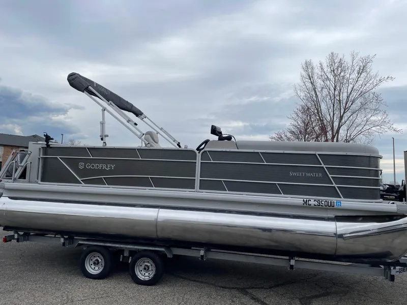Slide: The Image of 2022 Godfrey Sweetwater 2286 FS pontoon boat on trailer, parked outdoors. - 0