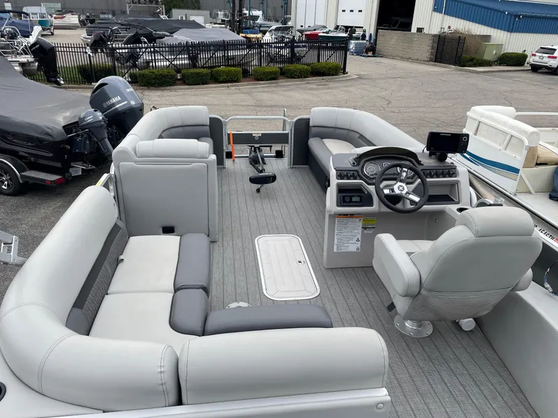 Slide: The Image of 2022 Godfrey Sweetwater 2286 FS pontoon boat interior with gray seating and steering console. - 10