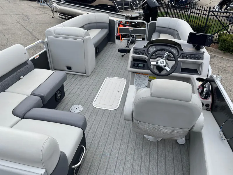 Slide: The Image of 2022 Godfrey Sweetwater 2286 FS pontoon boat interior with plush seating and modern helm. - 11