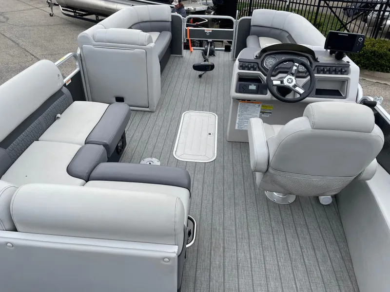 Slide: The Image of 2022 Godfrey Sweetwater 2286 FS pontoon boat interior with gray seating and steering console. - 12