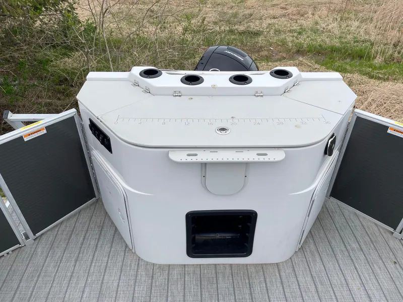 Slide: The Image of 2022 Godfrey Sweetwater 2286 FS boat console with cup holders and storage compartments. - 14