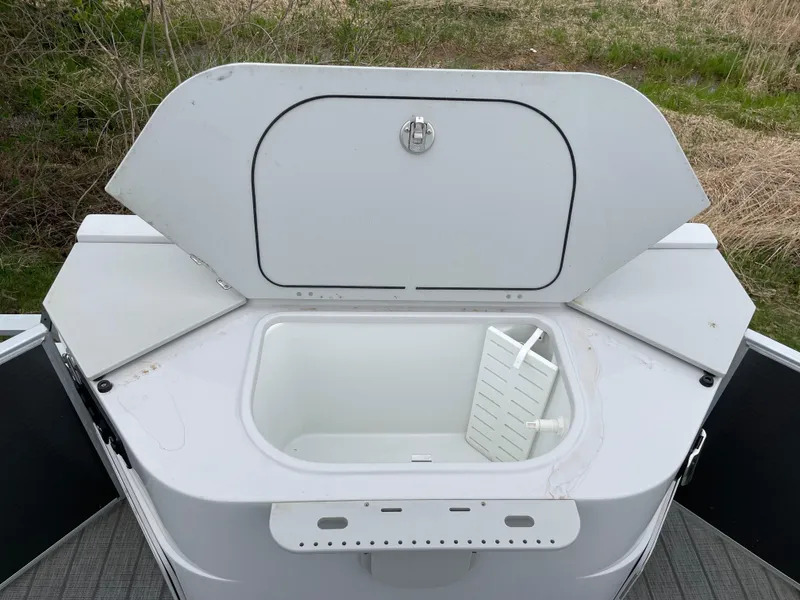 Slide: The Image of Open storage compartment on 2022 Godfrey Sweetwater 2286 FS boat, showcasing interior space. - 15