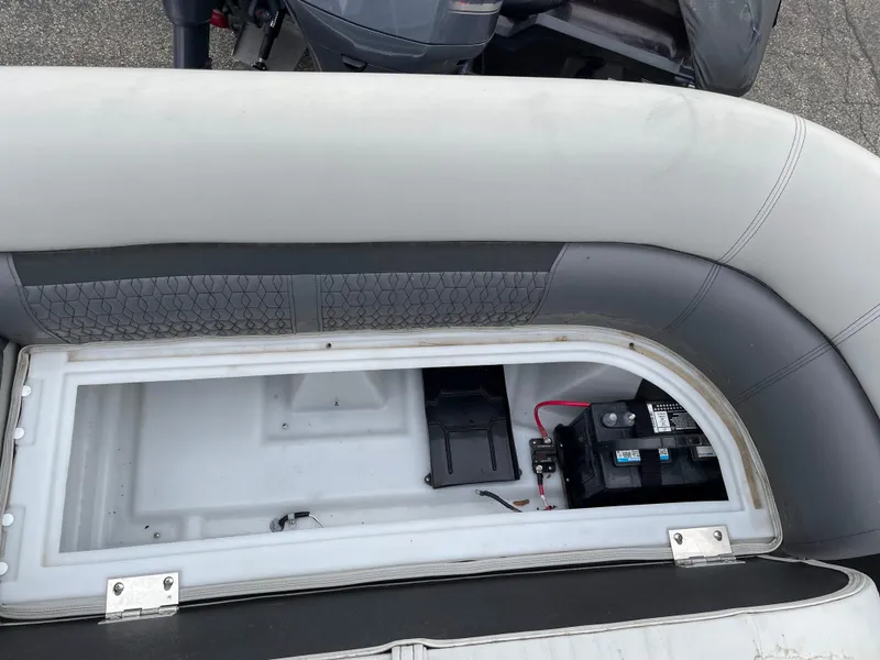 Slide: The Image of Open storage compartment in a 2022 Godfrey Sweetwater 2286 FS pontoon boat. - 16