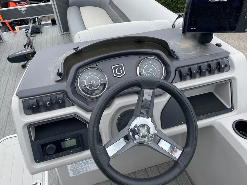 Slide: The Image of 2022 Godfrey Sweetwater 2286 FS boat dashboard with steering wheel and control panel. - 6
