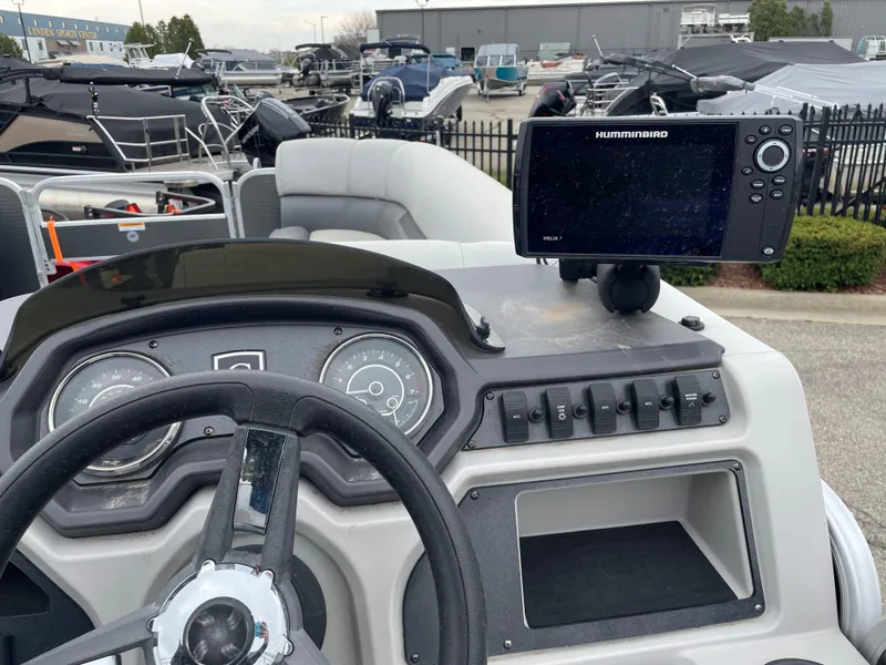 Slide: The Image of 2022 Godfrey Sweetwater 2286 FS boat dashboard with steering wheel and Humminbird fish finder. - 7
