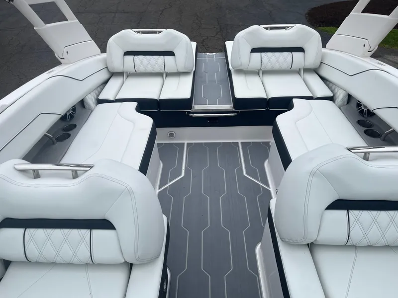 Slide: The Image of 2025 Regal LS4 Surf boat interior with luxurious white seating and sleek design. - 10