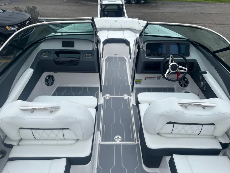 Slide: The Image of 2025 Regal LS4 Surf boat interior with modern seating and sleek dashboard design. - 11