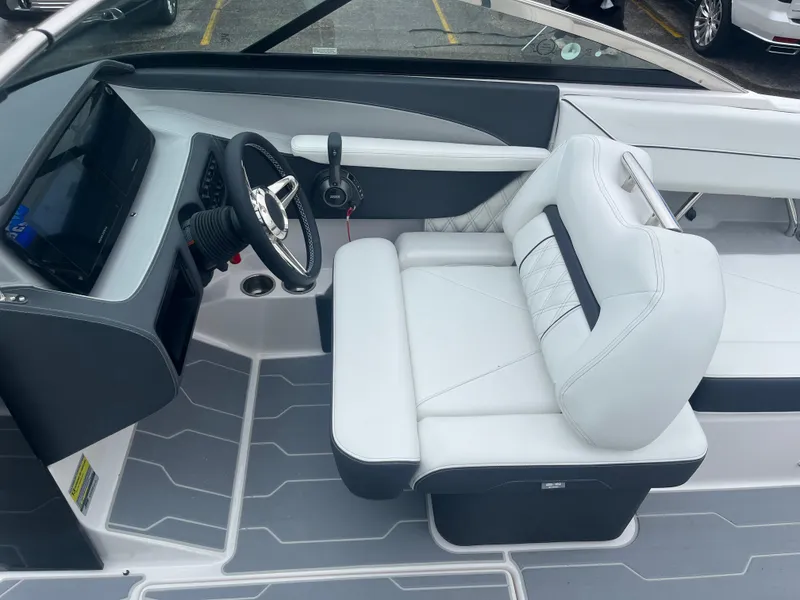 Slide: The Image of 2025 Regal LS4 Surf boat interior with sleek white seating and modern dashboard. - 14