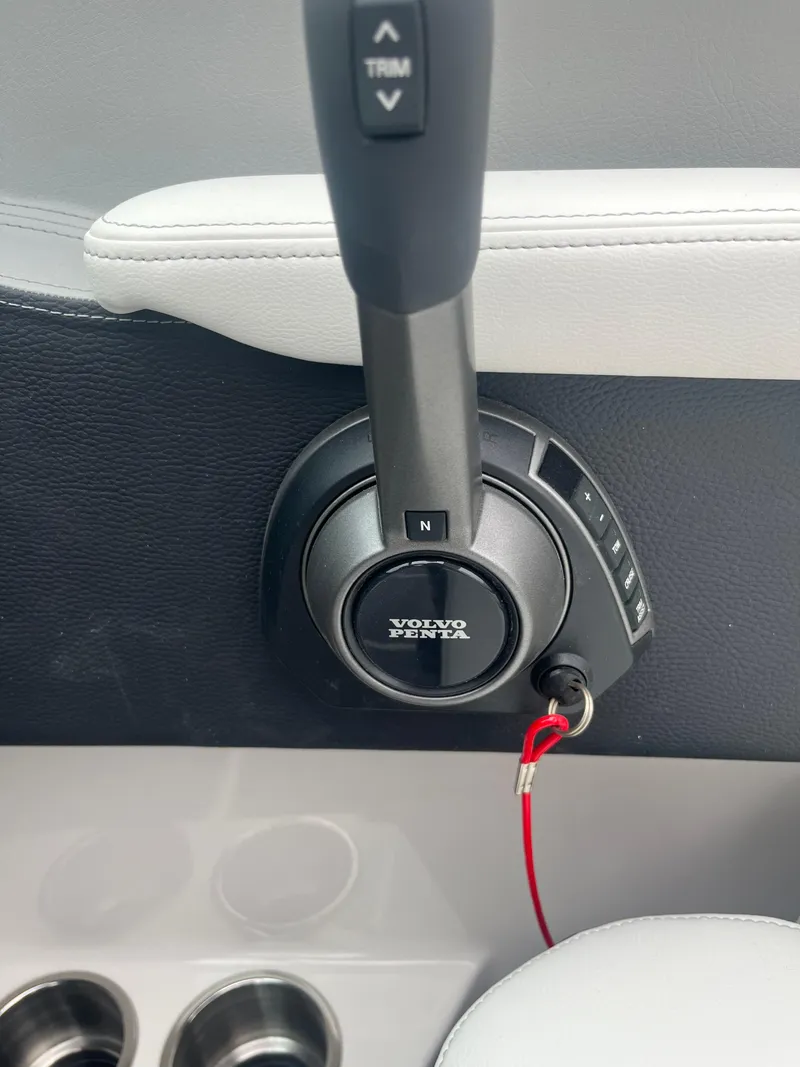 Slide: The Image of 2025 Regal LS4 Surf boat throttle control with Volvo Penta branding. - 19