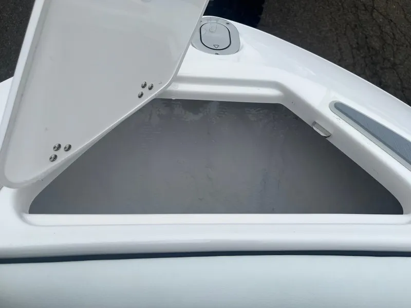 Slide: The Image of Open storage compartment on 2025 Regal LS4 Surf boat. - 2