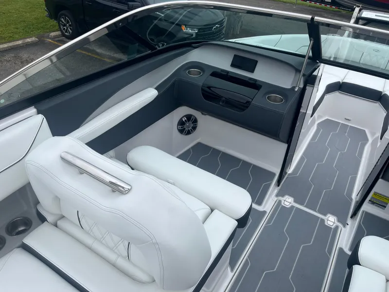 Slide: The Image of 2025 Regal LS4 Surf boat interior with white seating and modern dashboard design. - 9
