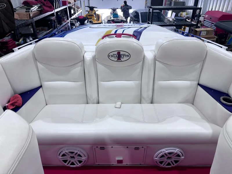 Slide: The Image of 2004 Cigarette 38 Top Gun boat interior with white seating and logo. - 17