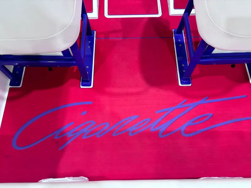 Slide: The Image of Red boat floor mat with "Cigarette" logo, blue accents, 2004 Cigarette 38 Top Gun model. - 18