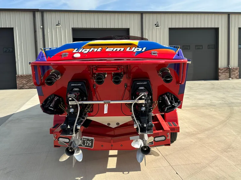 Slide: The Image of Rear view of a colorful 2004 Cigarette 38 Top Gun boat with dual engines. - 2