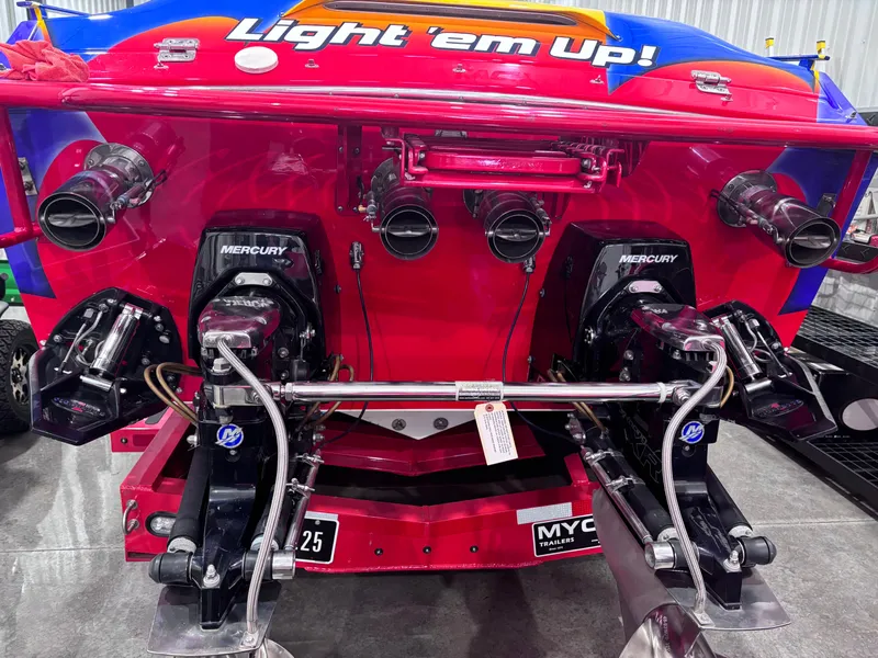 Slide: The Image of 2004 Cigarette 38 Top Gun boat, vibrant colors, dual Mercury engines, "Light 'em Up!" text. - 20