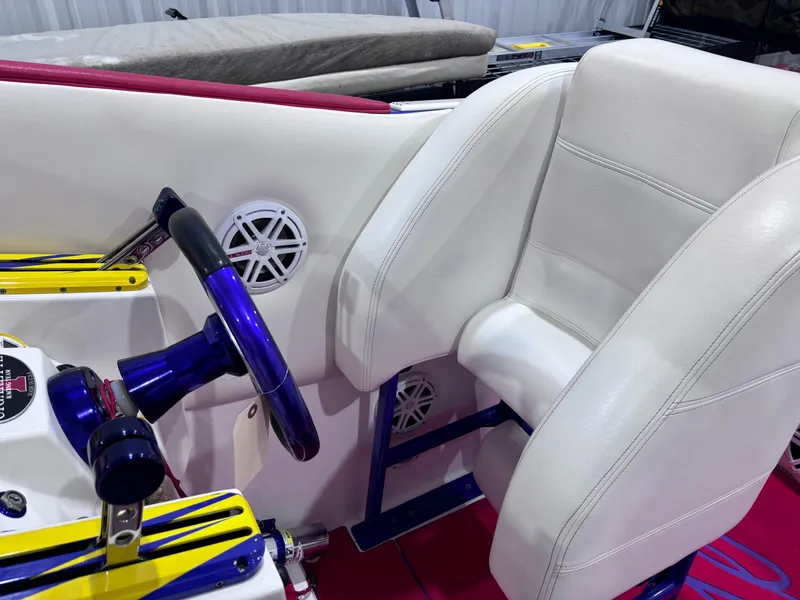 Slide: The Image of 2004 Cigarette 38 Top Gun boat interior with white seating and blue steering wheel. - 21