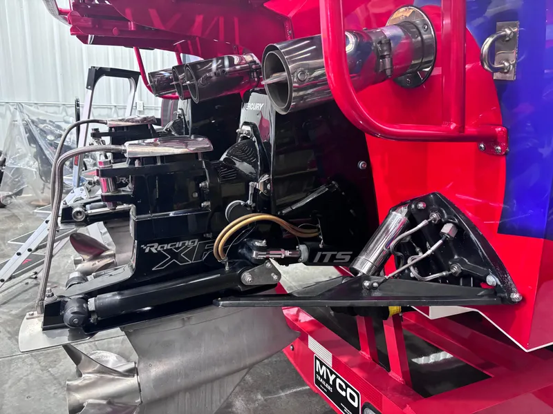 Slide: The Image of 2004 Cigarette 38 Top Gun boat engine and exhaust system in a workshop setting. - 25