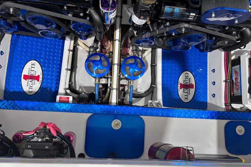 Slide: The Image of Engine compartment of a 2004 Cigarette 38 Top Gun boat with blue accents and branded components. - 26
