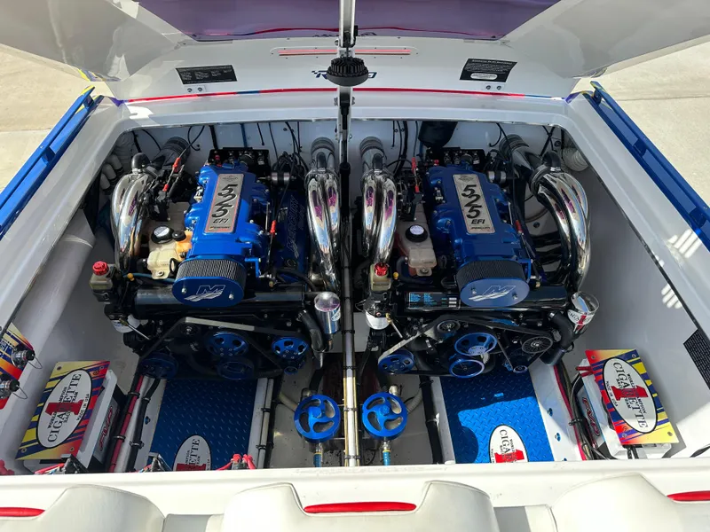 Slide: The Image of 2004 Cigarette 38 Top Gun engine compartment with dual blue engines and chrome details. - 3