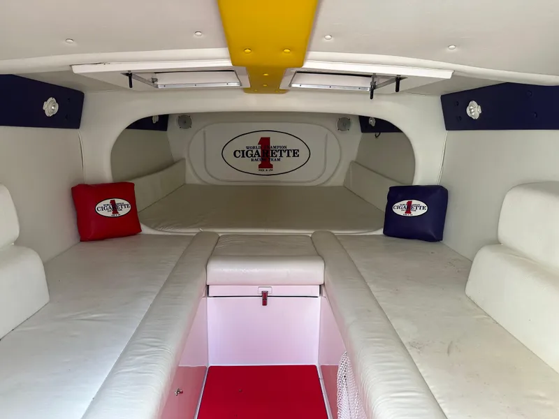 Slide: The Image of Interior of 2004 Cigarette 38 Top Gun boat with white seating and branded cushions. - 32