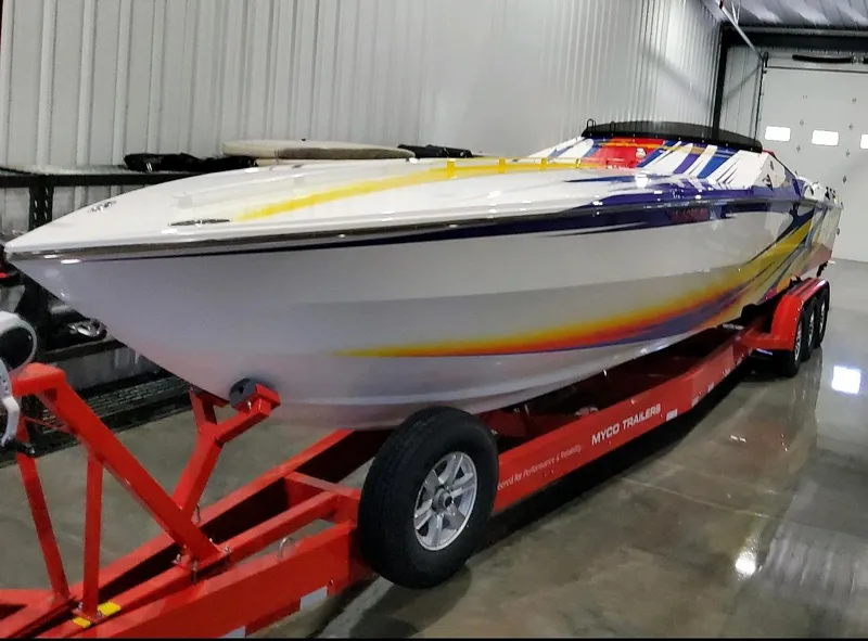 Slide: The Image of 2004 Cigarette 38 Top Gun boat on red trailer in indoor storage. - 40