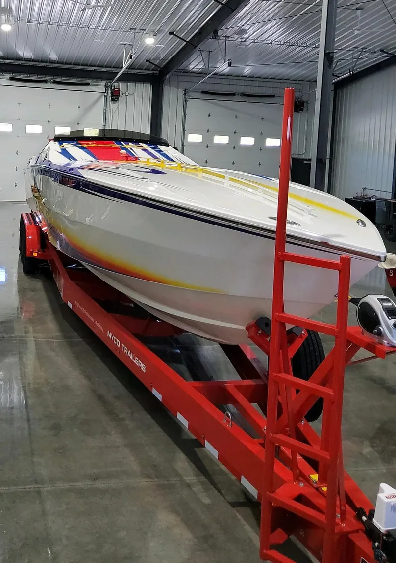 Slide: The Image of 2004 Cigarette 38 Top Gun boat on red trailer in a garage. - 41