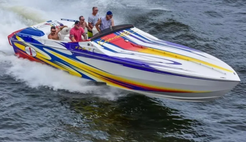 Slide: The Image of 2004 Cigarette 38 Top Gun speedboat with colorful graphics on water. - 42