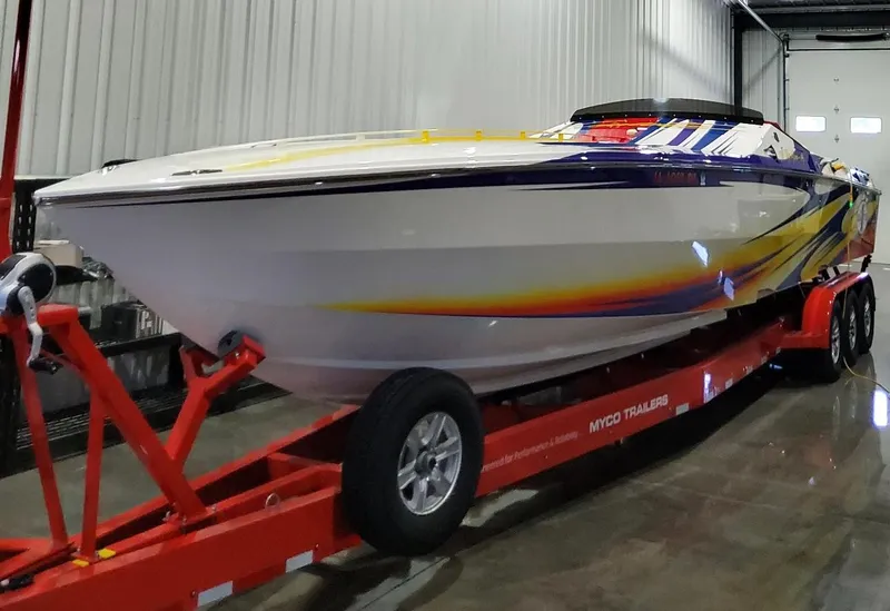 Slide: The Image of 2004 Cigarette 38 Top Gun speedboat on red trailer in indoor storage. - 44
