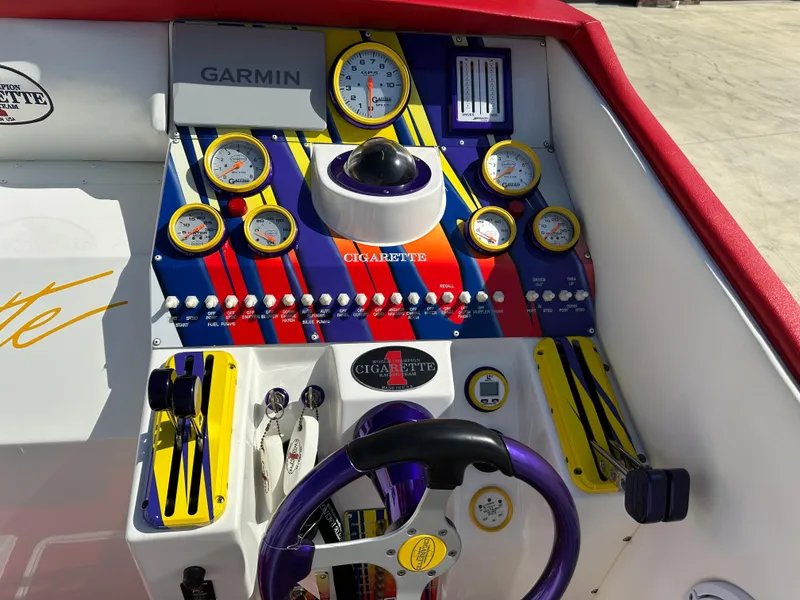 Slide: The Image of 2004 Cigarette 38 Top Gun dashboard with colorful gauges and Garmin navigation system. - 6