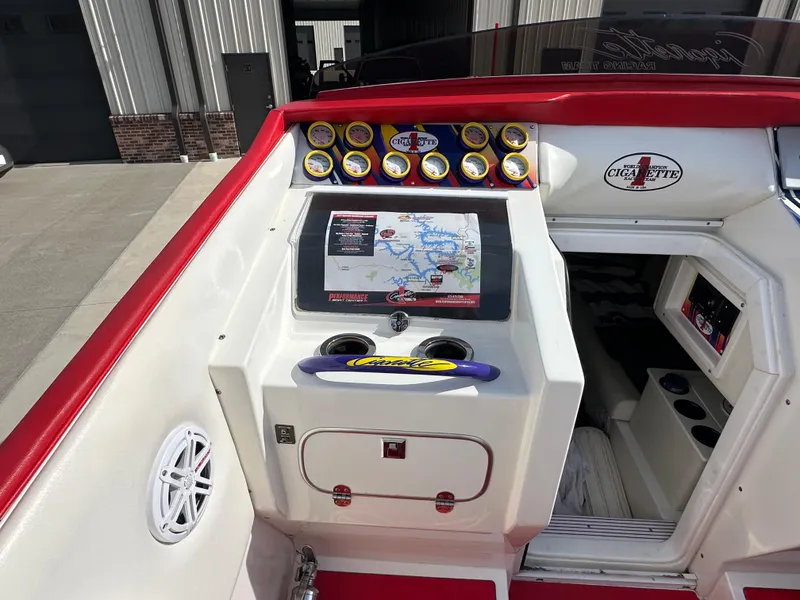 Slide: The Image of 2004 Cigarette 38 Top Gun boat dashboard with gauges and navigation screen. - 8