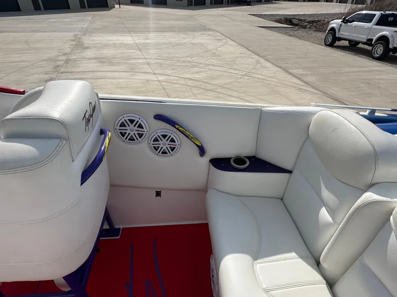 Slide: The Image of Interior of a 2004 Cigarette 38 Top Gun boat with white seating and speakers. - 9