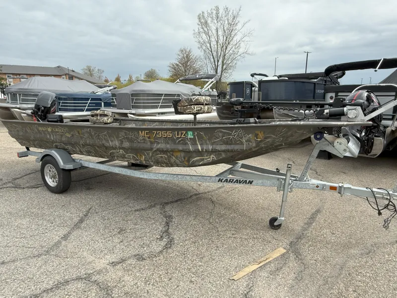 Slide: The Image of 2024 War Eagle 754LDV Sportsman boat on Karavan trailer in parking lot. - 0