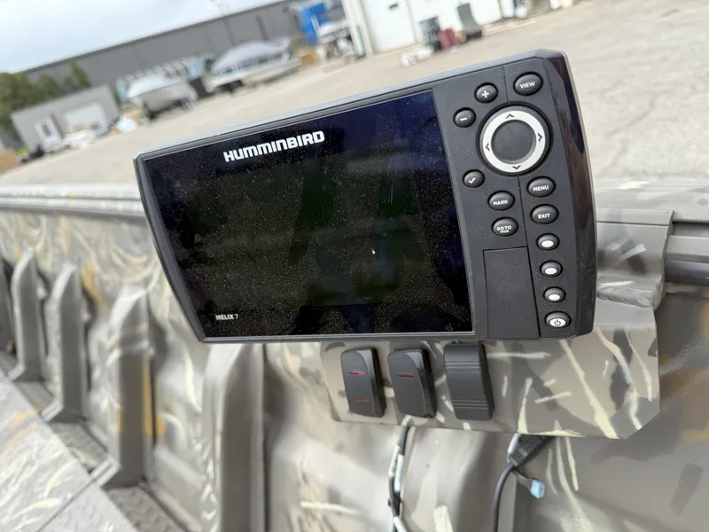 Slide: The Image of Fishfinder on 2024 War Eagle 754LDV Sportsman boat, featuring camo interior and control panel. - 10