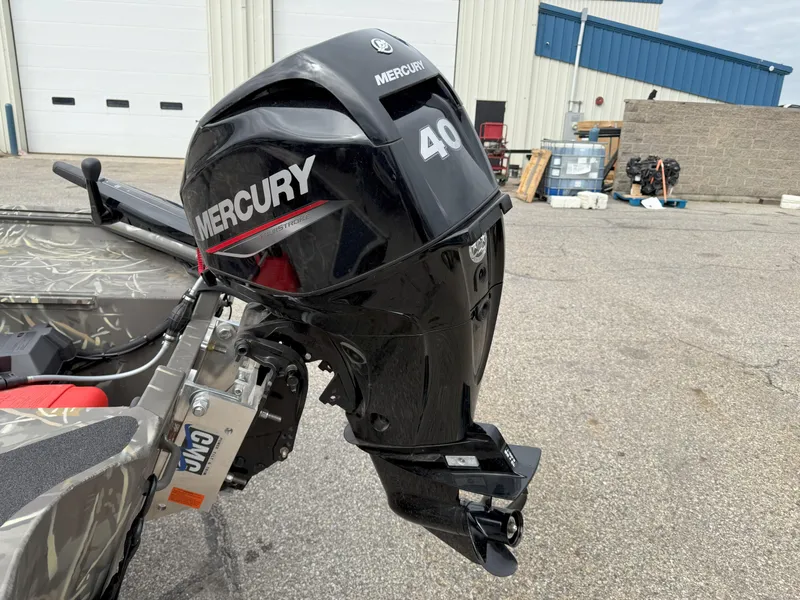 Slide: The Image of 2024 War Eagle 754LDV Sportsman with Mercury 40 outboard motor in a parking lot. - 5