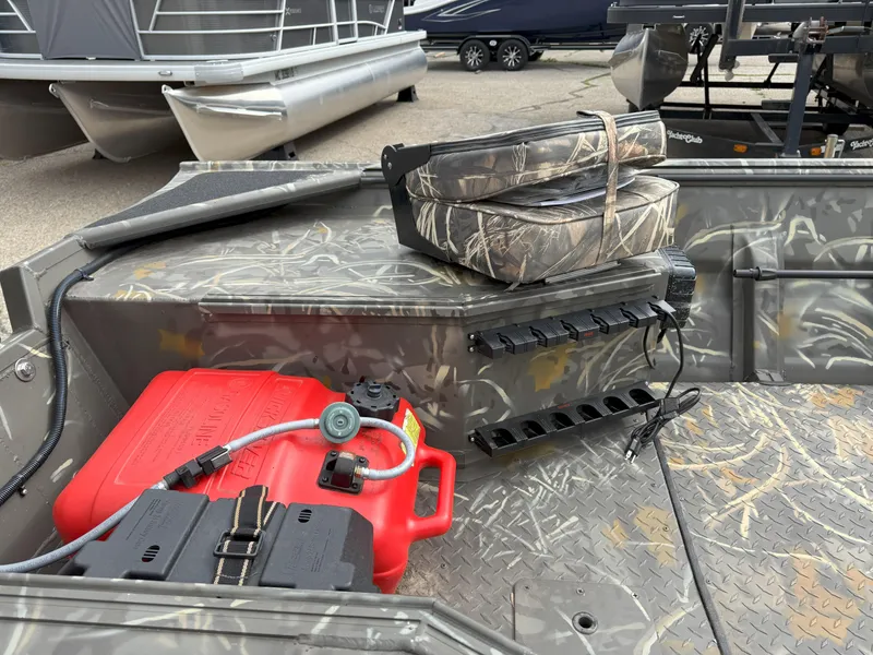 Slide: The Image of 2024 War Eagle 754LDV Sportsman boat interior with camouflage seats and fuel tank. - 8