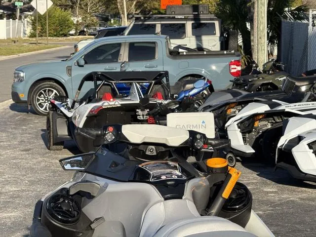 Slide: The Image of 2023 Sea-Doo Waverunner FishPro™ Trophy parked with other vehicles in a lot. - 10