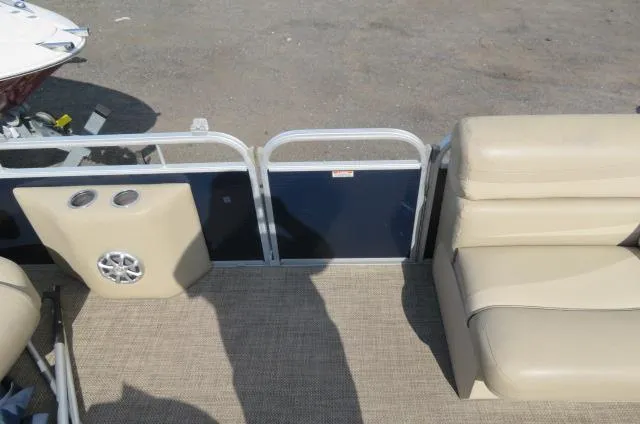 Slide: The Image of 2014 Bennington 2275 GCW pontoon boat interior with beige seating and speaker. - 11