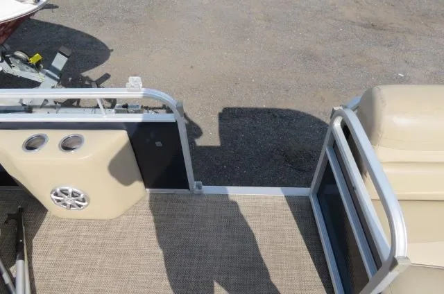 Slide: The Image of 2014 Bennington 2275 GCW pontoon boat interior with beige seating and speaker system. - 12